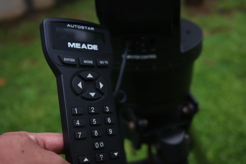 Meade Autostar controller in hand with the ETX 90 in background