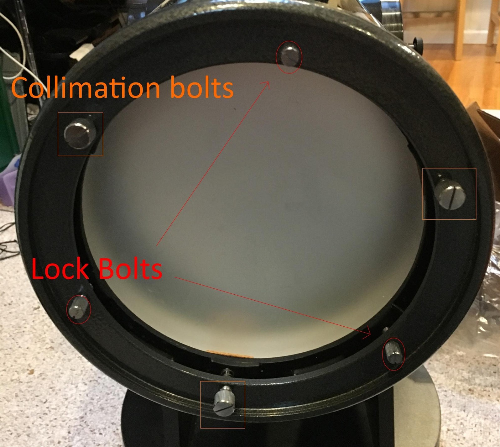Three collimation screws and three locking screws in the back of a dobsonian reflector's optical tube