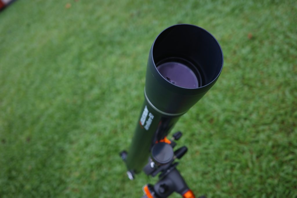 Astromaster 90EQ's lens and dew shield on its optical tube